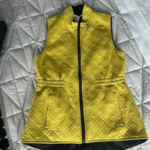 Cabi chartreuse green vest with black lining and black zipper.